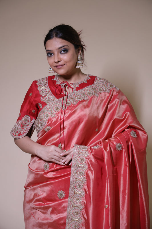 Woman wearing a pink saree with intricate designs on a beige background Red Silk Heritage zardozi Saree