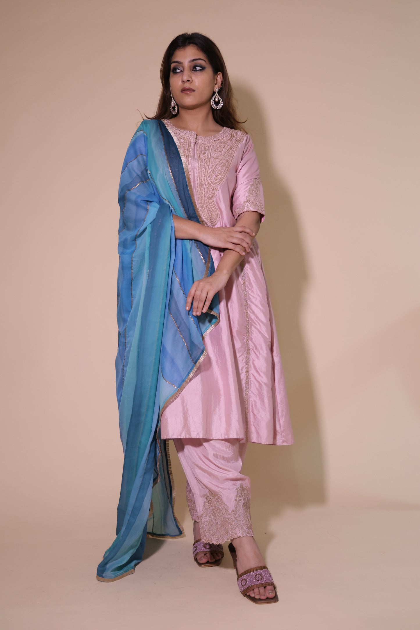Woman wearing a pink dress with a blue shawl on a beige background Rose Pink A-Line Chola Kurta with Salwar with Blue Dupatta