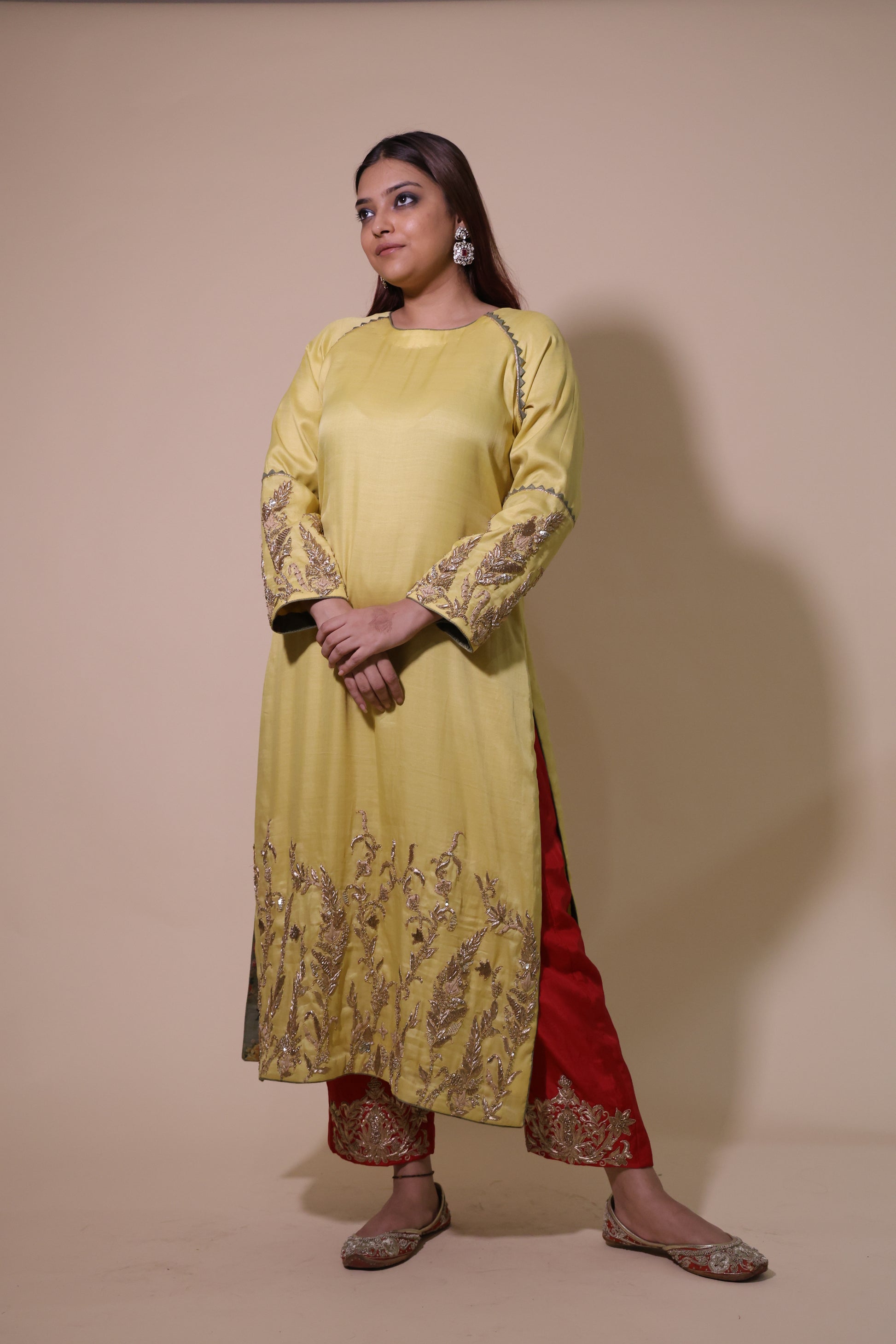 Woman wearing a yellow and red traditional outfit on a beige background Yellow Silk Kurta with Zardozi Handwork & Red Palazzo